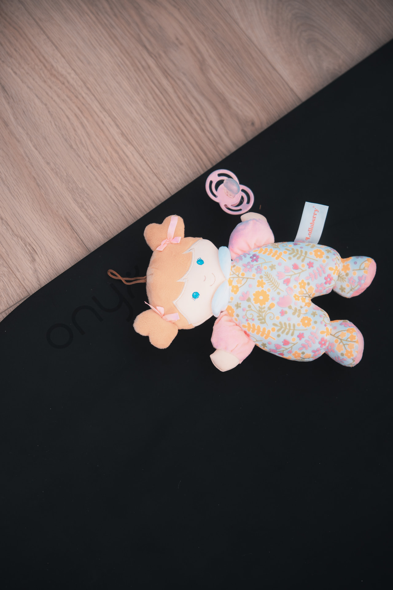 Soft toy and dummy resting on a mat during a Baby & Me class